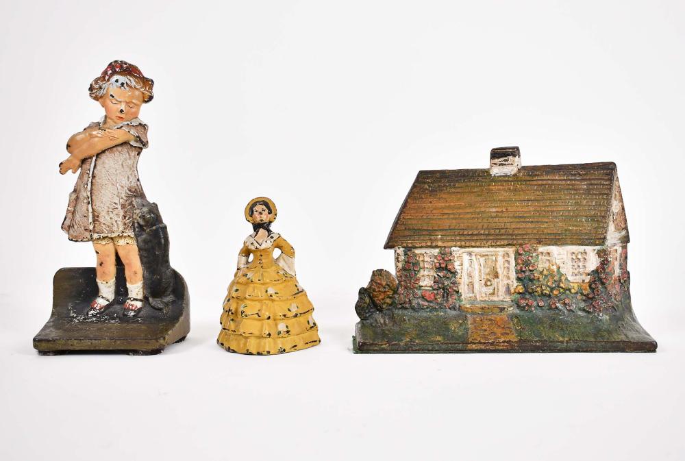 Appraisal: THREE VARIED PAINTED CAST IRON DOORSTOPS to Comprising a lady