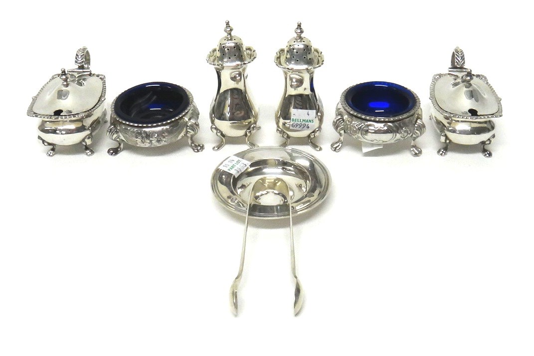 Appraisal: Silver condiments comprising a pair of pepperettes each raised on