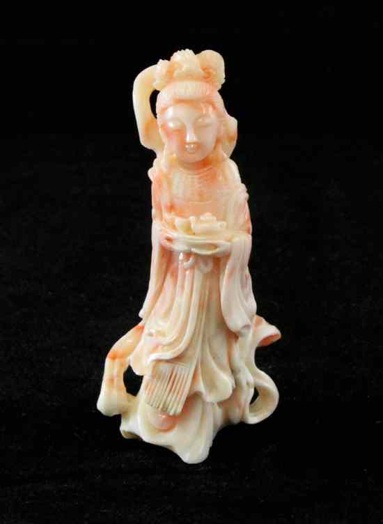 Appraisal: A Chinese coral figure of a female immortal standing holding