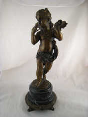 Appraisal: A bronze figure of Cupid distributing flowers on a marble