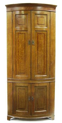 Appraisal: A late George III oak bowfront standing corner cupboard with