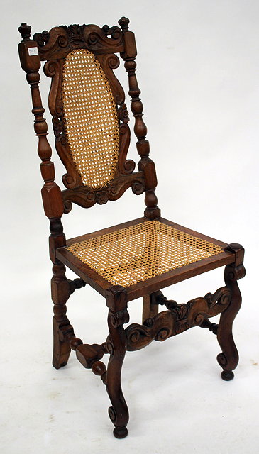 Appraisal: AN ANTIQUE JACOBEAN STYLE WALNUT AND CANED CHAIR with carved