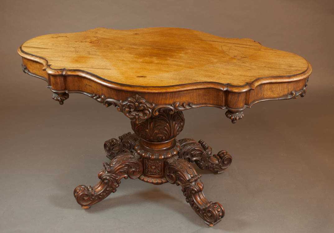 Appraisal: VICTORIAN CARVED WALNUT CENTER TABLE English th century having an