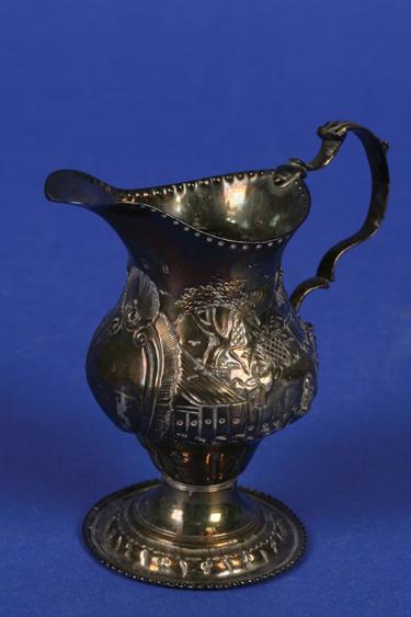 Appraisal: A GEORGE III CREAM JUG of baluster form with a