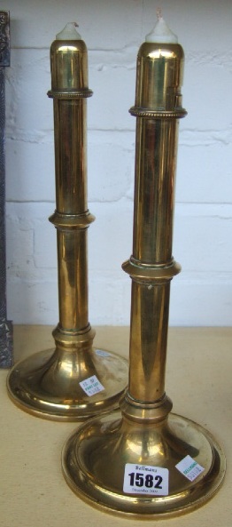 Appraisal: A pair of brass ejector candlesticks th century cm high