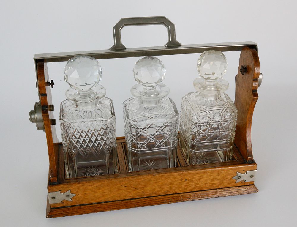 Appraisal: Oak and Crystal Tantalus Set th Century Oak and Crystal