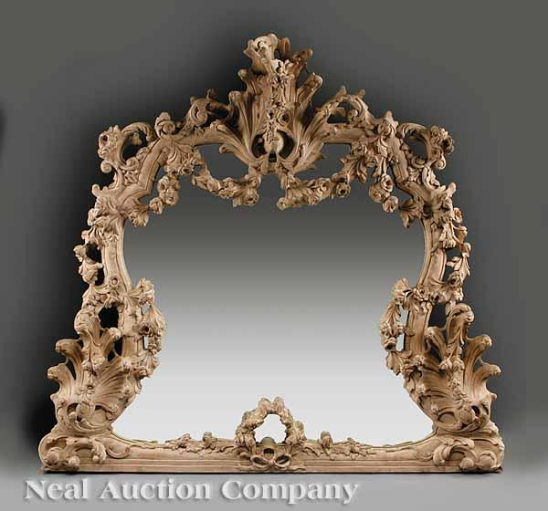 Appraisal: A German Rococo-Style Carved Pine Overmantel Mirror exuberantly carved scalloped