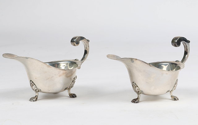 Appraisal: A PAIR OF SILVER SAUCE BOATS with pad feet and