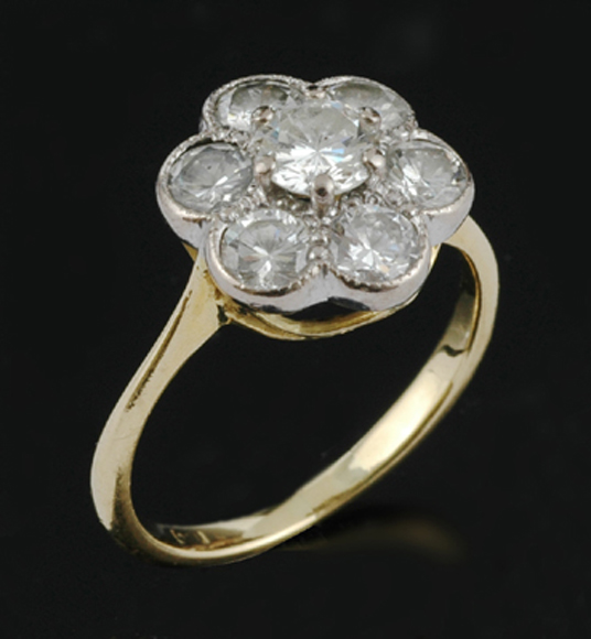 Appraisal: A diamond flower cluster ring Comprising seven round brilliant cut