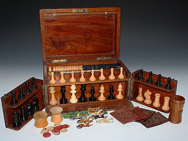 Appraisal: A MAHOGANY GAMING COMPENDIUM for chess draughts cribbage wist dominoes