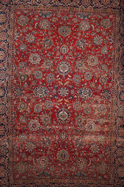 Appraisal: A PERSIAN KASHAN CARPET decorated with allover foliate motifs on