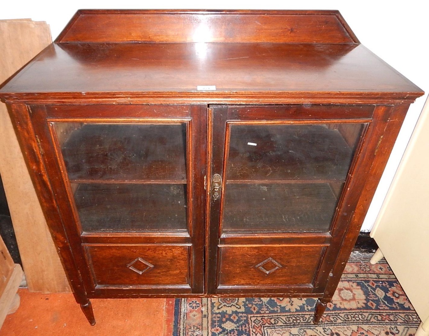 Appraisal: A mahogany stained side cabinet enclosed by two glazed doors