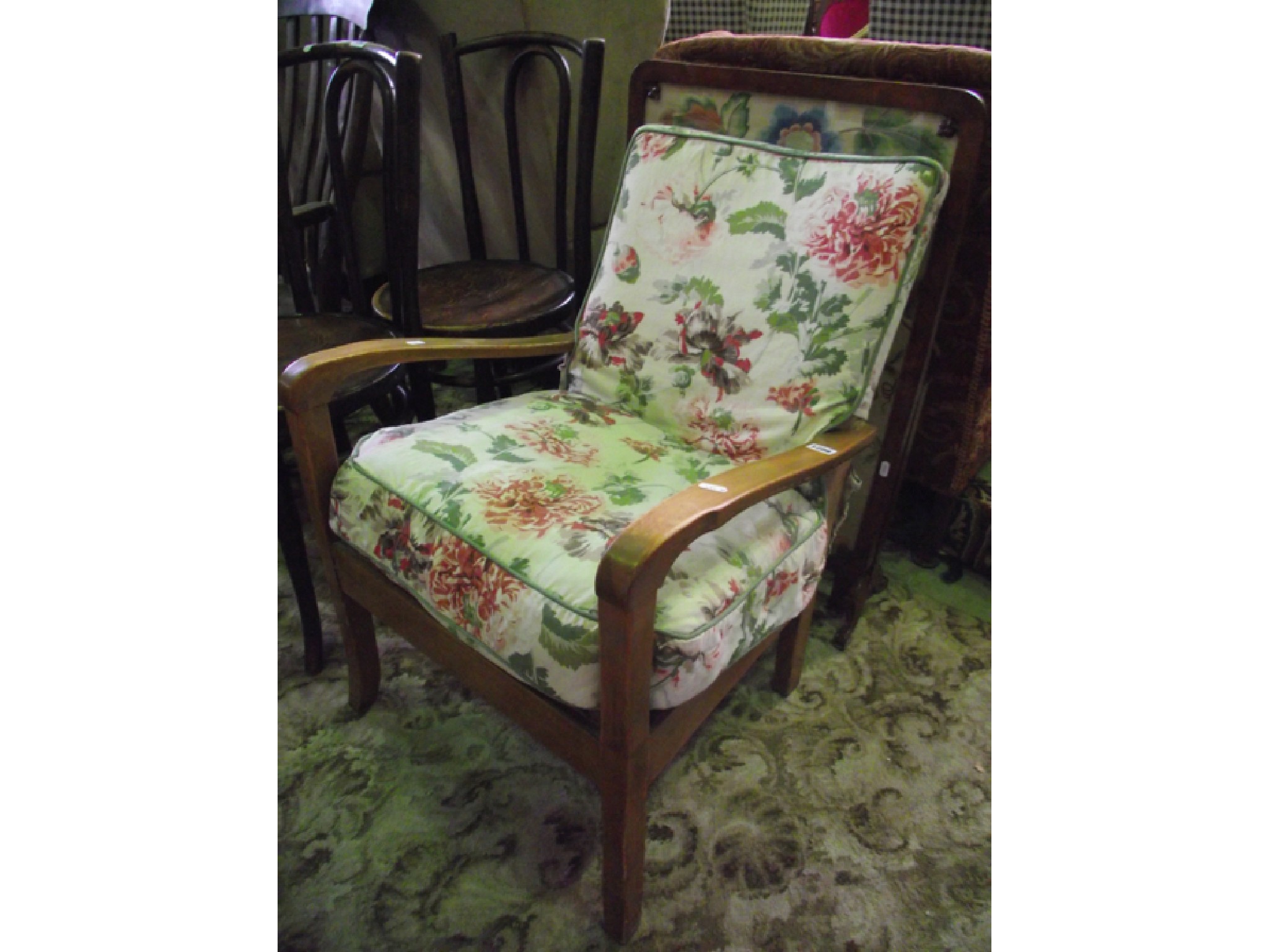 Appraisal: A fireside chair with show wood frame and upholstered seat