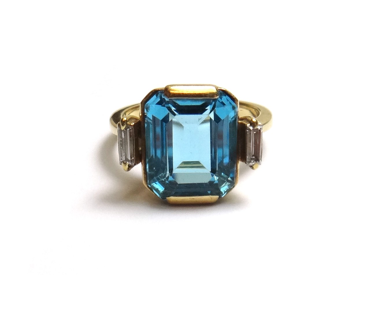 Appraisal: A gold blue topaz and diamond set three stone ring