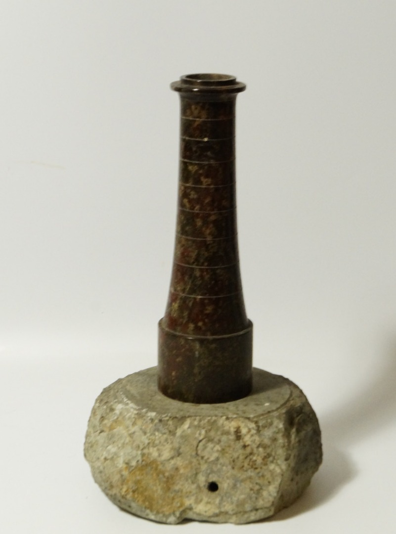 Appraisal: A serpentine model lighthouse table lamp with rock base cm