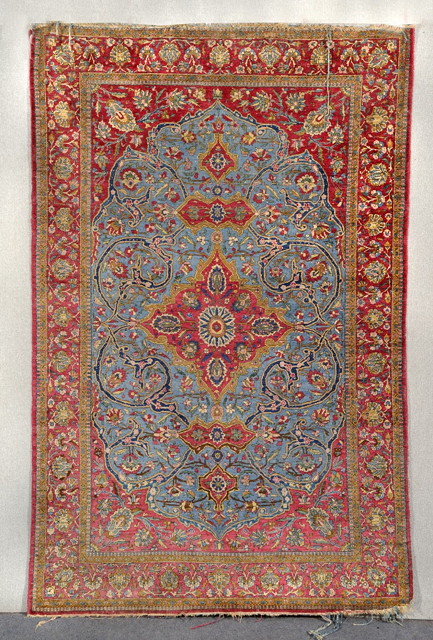 Appraisal: AN ISFAHAN BLUE GROUND SILK RUG decorated a central foliate