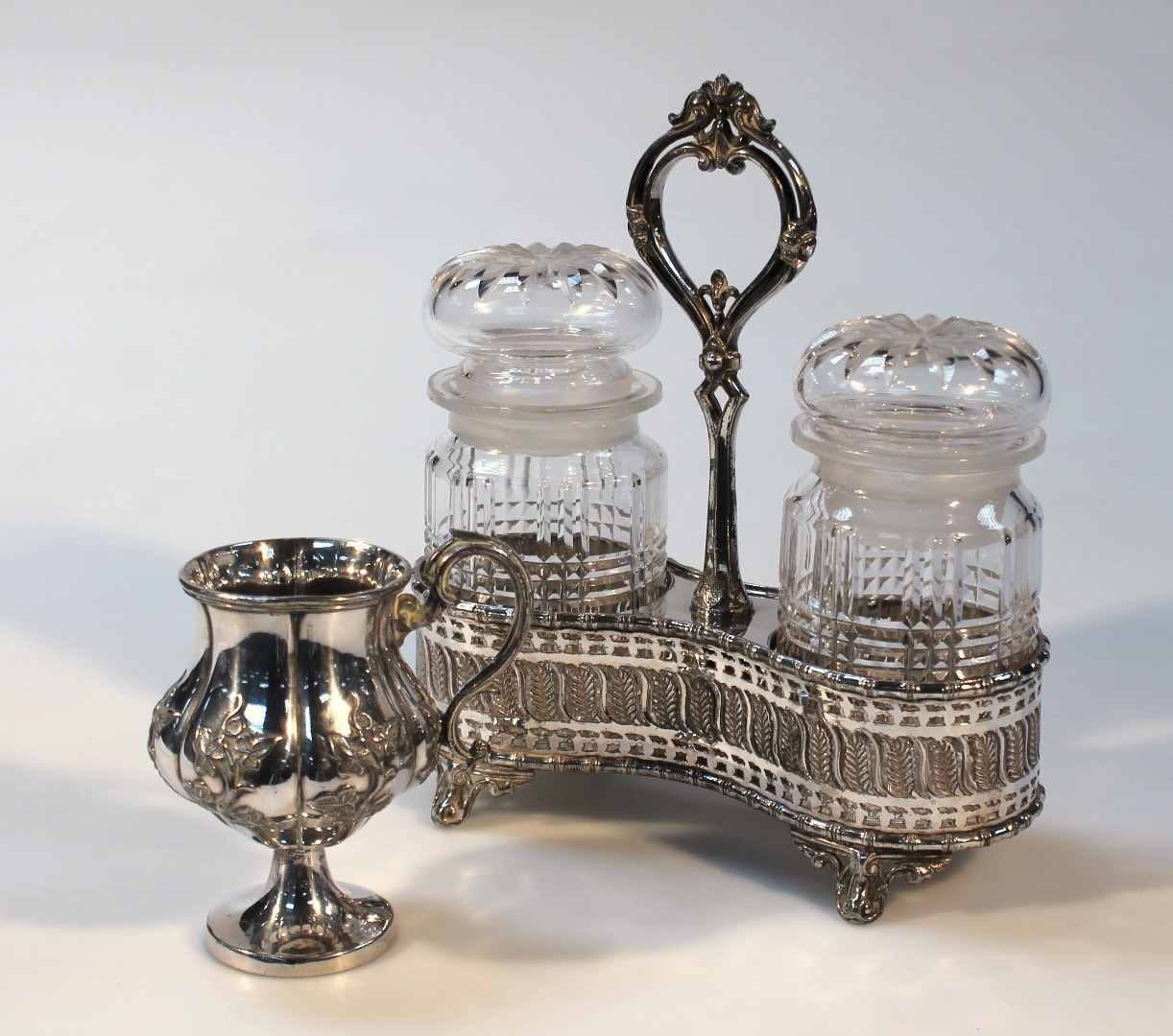 Appraisal: An Edwardian silver plated and glass jar set with two