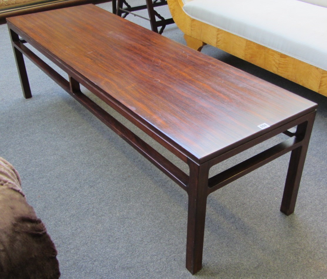 Appraisal: A mid th century rectangular rosewood coffee table retailed by