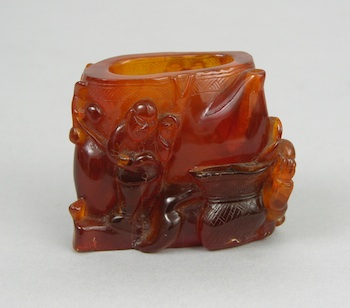 Appraisal: A Consolidated Amber Vase with Figures Chinese A small consolidated