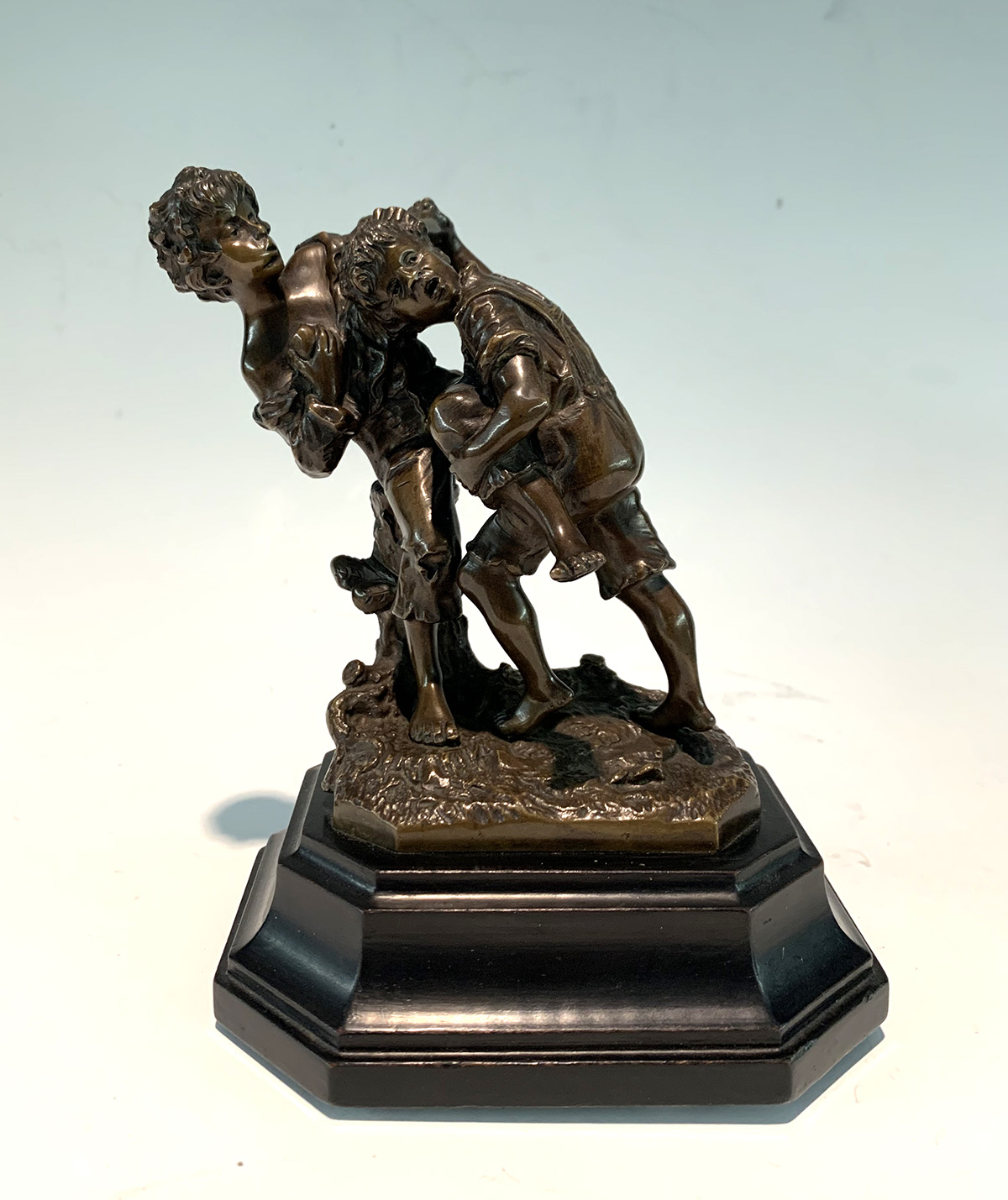 Appraisal: MINIATURE BRONZE YOUNGSTERS FIGHTING '' h affixed to beveled wooden