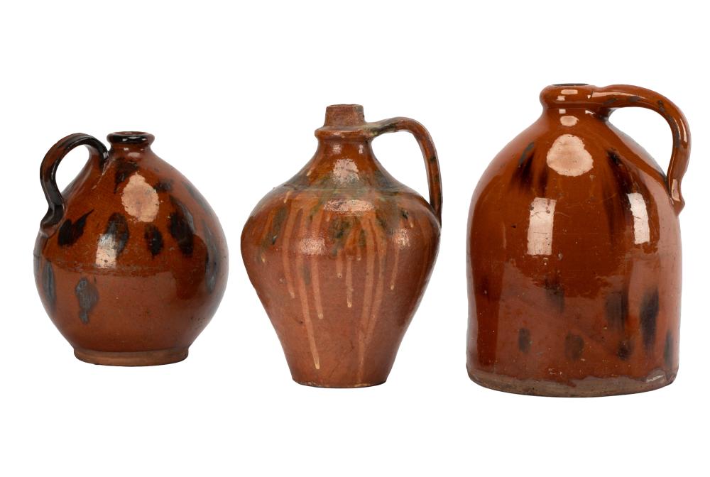 Appraisal: THREE AMERICAN REDWARE JUGS th century the first and second