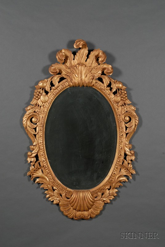 Appraisal: Rococo-style Giltwood Oval Mirror th century frame carved and molded