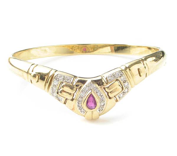 Appraisal: A diamond ruby and k gold bangle centering one pear