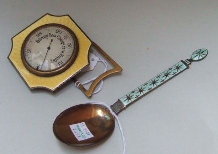 Appraisal: A yellow enameled strut backed travelling aneroid barometer with a