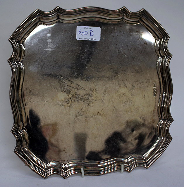 Appraisal: A SILVER SQUARE SALVER with serpentine pie crust edge marks