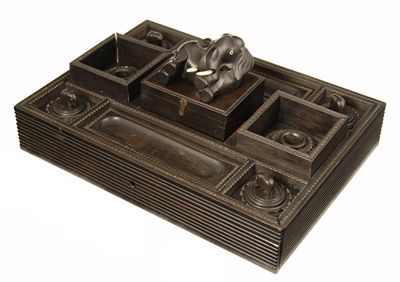 Appraisal: An Anglo-Indian ebonised ink stand with a central lidded box