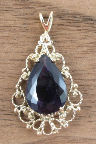 Appraisal: AMETHYST AND FOURTEEN KARAT GOLD PENDANT set with a pear-cut