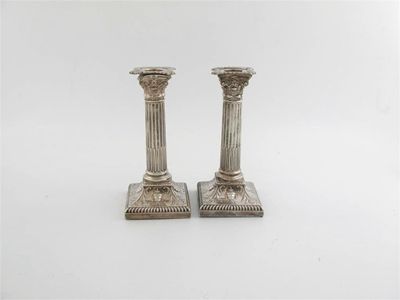 Appraisal: A pair of early th century corinthian candlesticks with fluted