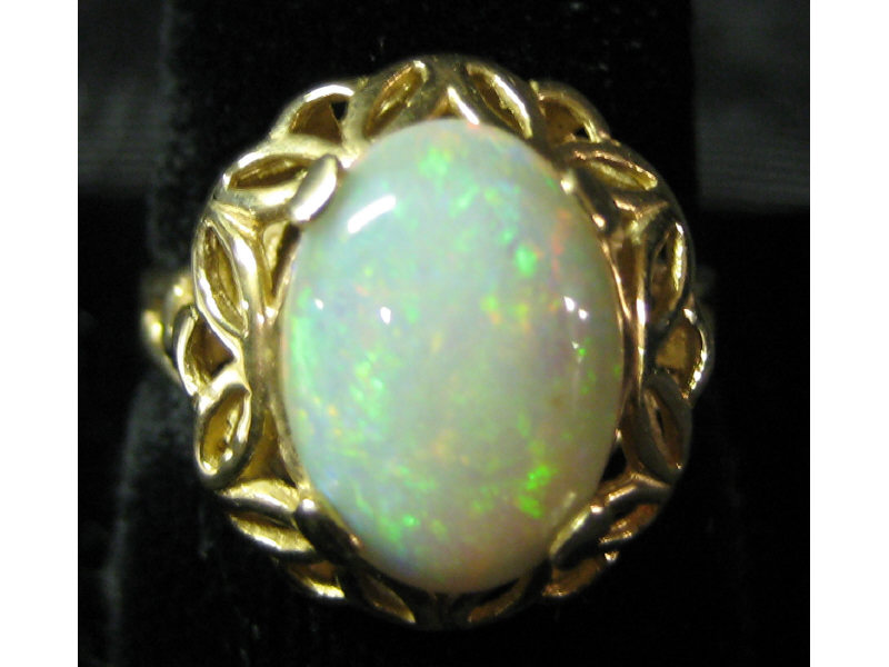 Appraisal: OPAL RING k yellow gold ring with open design border