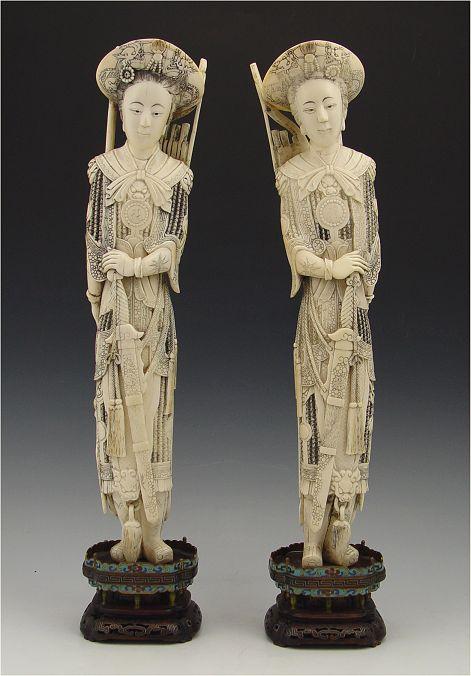 Appraisal: PAIR CARVED IVORY FEMALE WARRIORS Single tusks carved in mirror