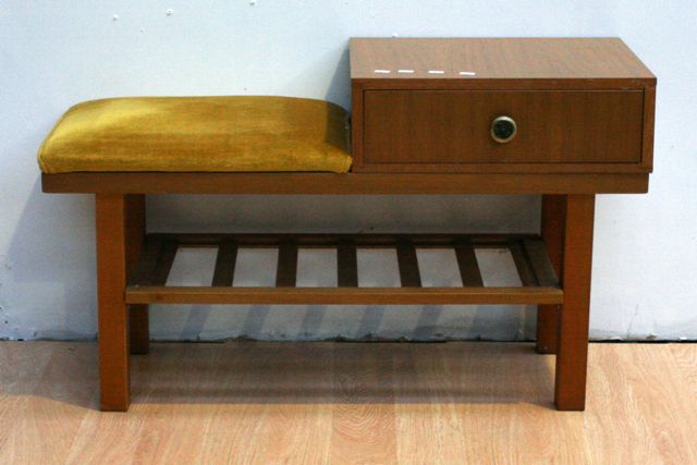 Appraisal: A retro timber veneered telephone table with yellow upholstery