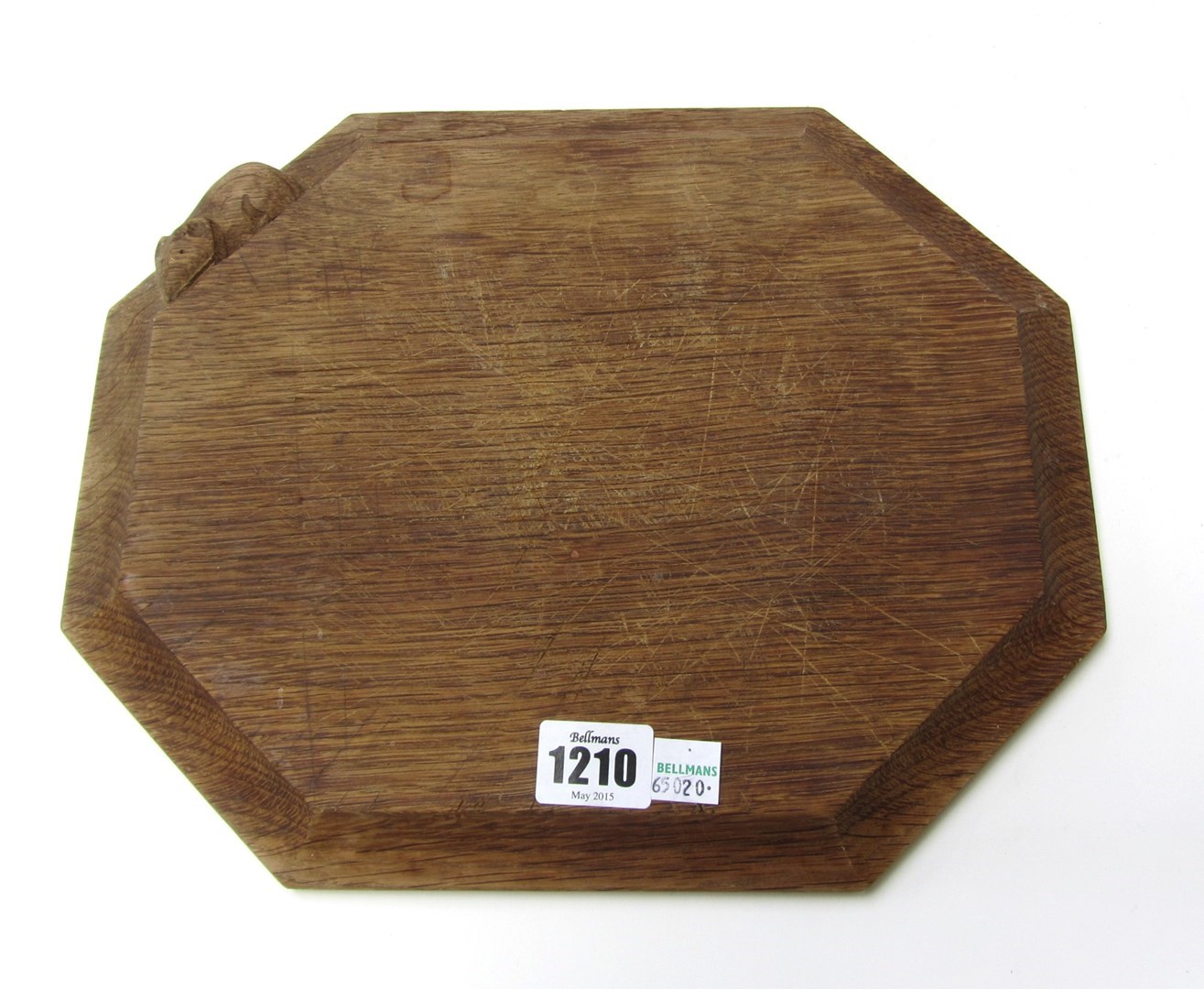 Appraisal: An oak chopping board of compressed octagonal form by Robert