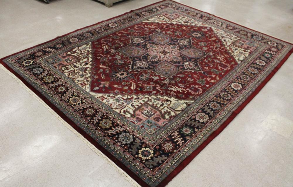 Appraisal: HAND KNOTTED ORIENTAL CARPET Indo-Serapi floral and central geometric medallion