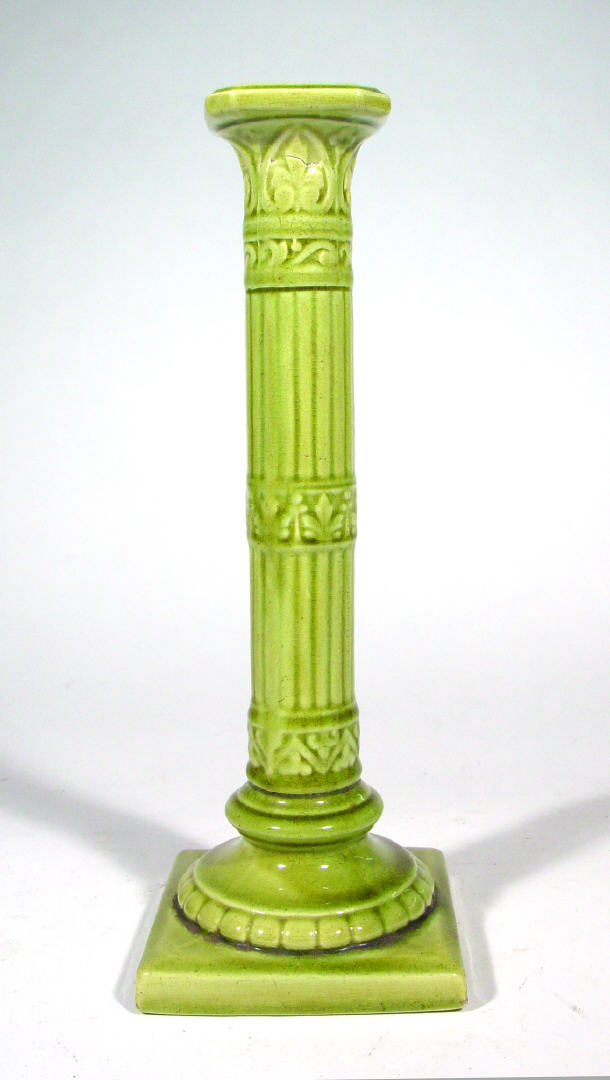 Appraisal: Burmantofts green glazed pottery candlestick with reeded stem factory marks