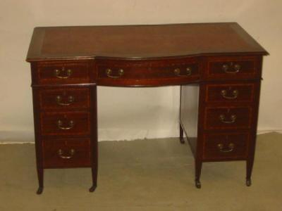 Appraisal: AN EDWARDIAN MAHOGANY PEDESTAL DESK of oblong form with bowed