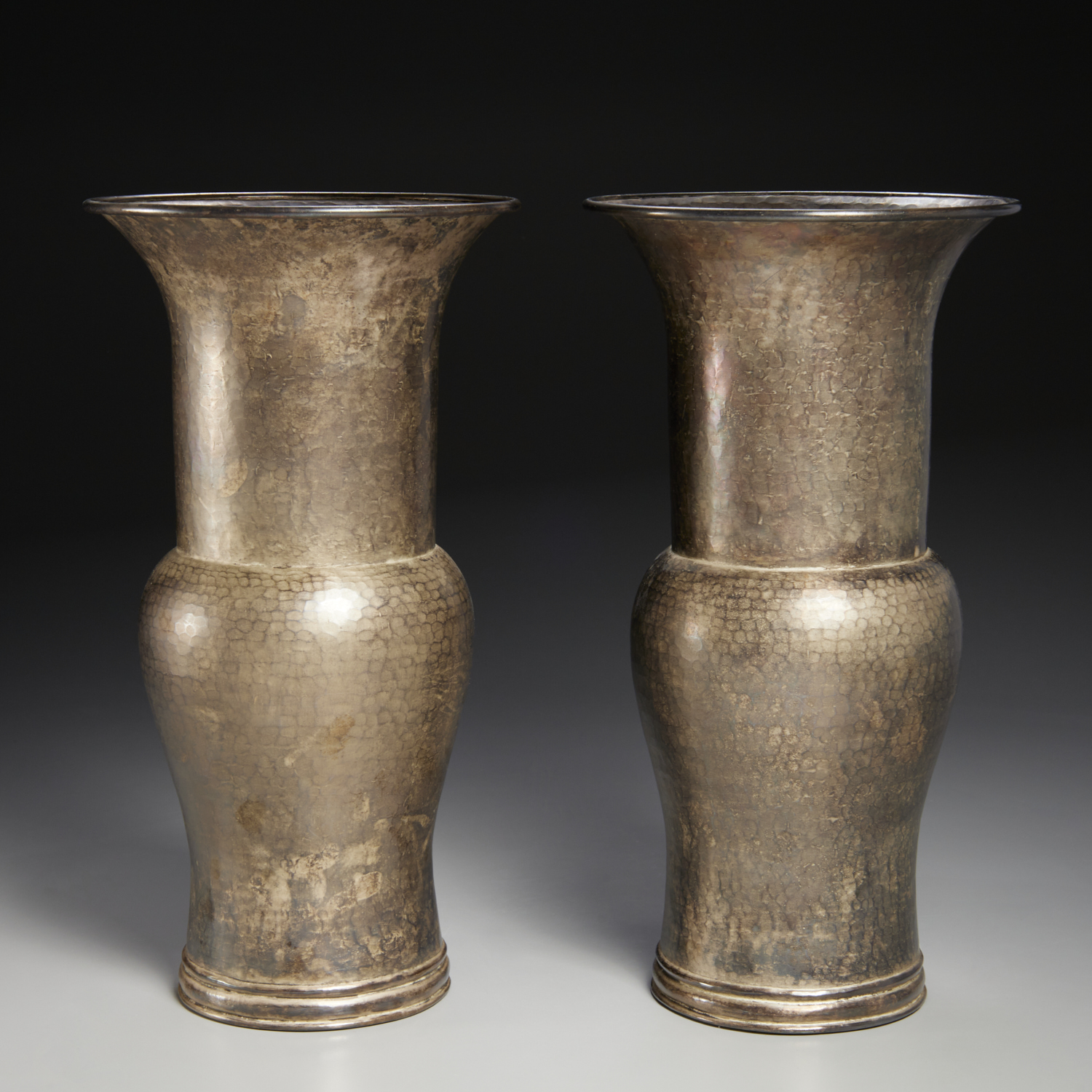 Appraisal: ROBERT KUO PAIR HAMMERED METAL ZUN VASES th st c