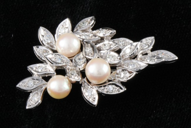 Appraisal: KW pearl and diamond pin Pin features round diamonds approximately