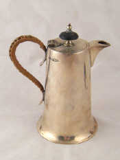 Appraisal: A silver cafe au lait pot with cane bound handle