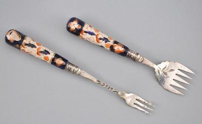 Appraisal: A Pair of Serving Forks with Porcelain Handles The slender