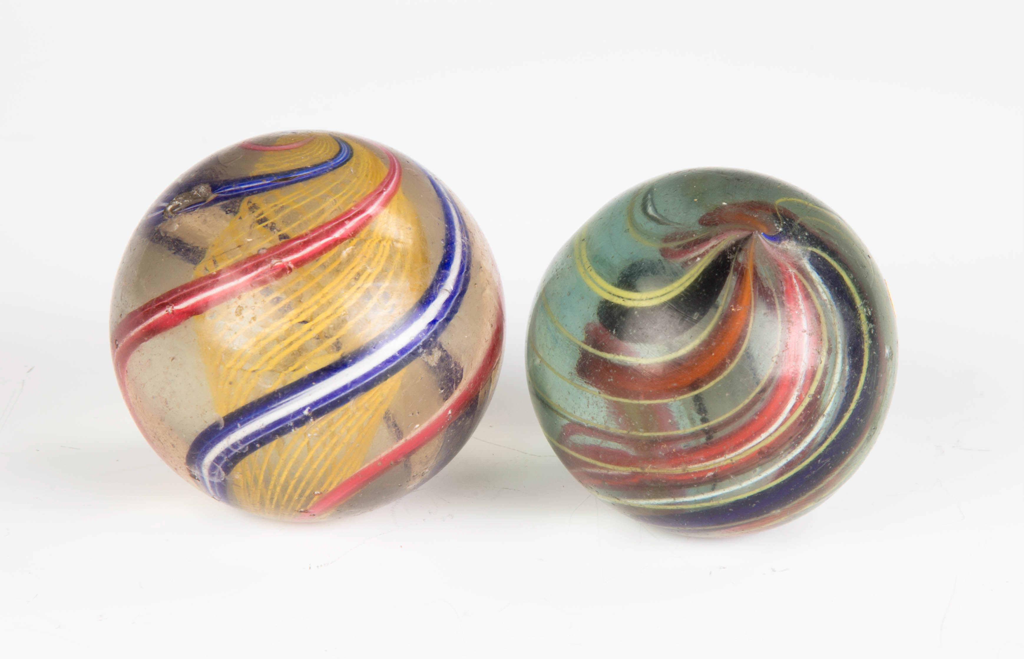 Appraisal: Two Large Vintage Swirl Marbles L - chips Dia R