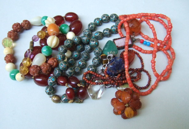 Appraisal: A vary coloured bead necklace a reconstituted amber bead necklace