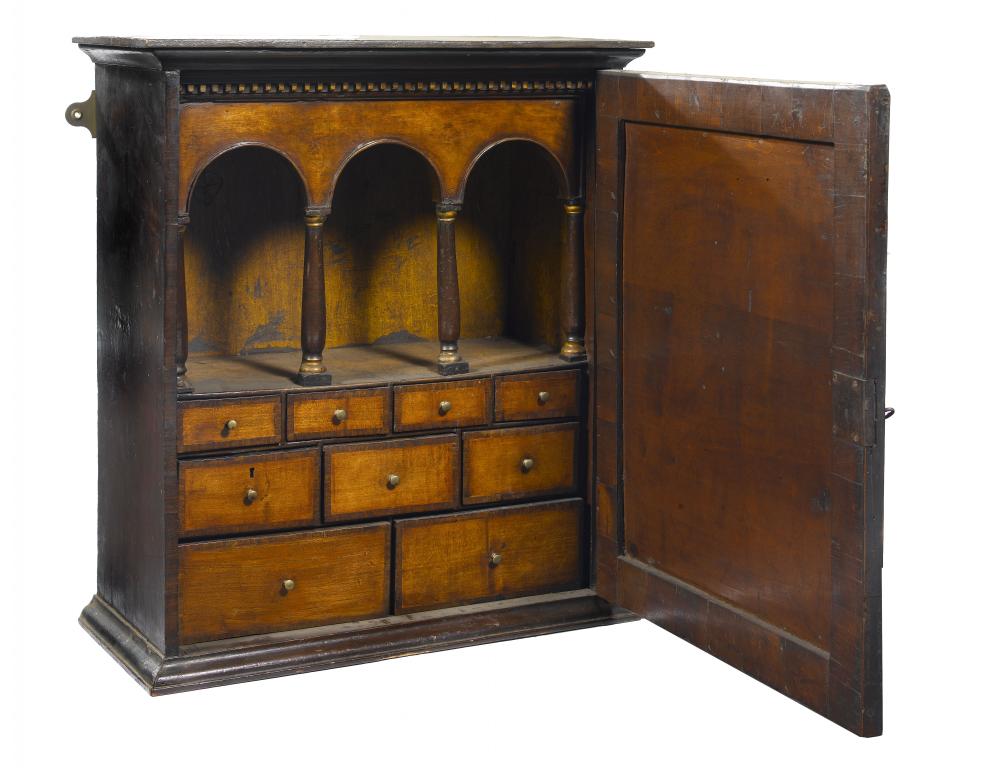 Appraisal: A WALNUT MURAL SPICE CUPBOARD the crossbanded and figured door