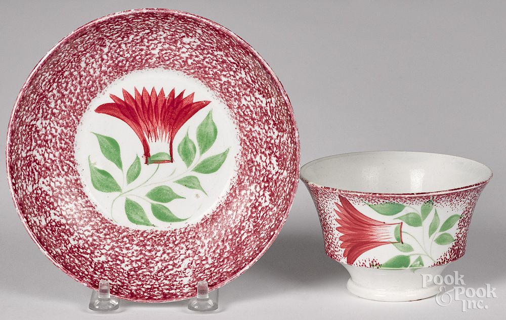 Appraisal: Purple red spatter thistle cup and saucer Purple red spatter