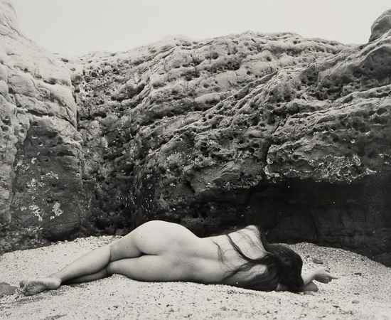 Appraisal: Yoshiyuki Iwase - Untitled Nude lying in rocky cove ca