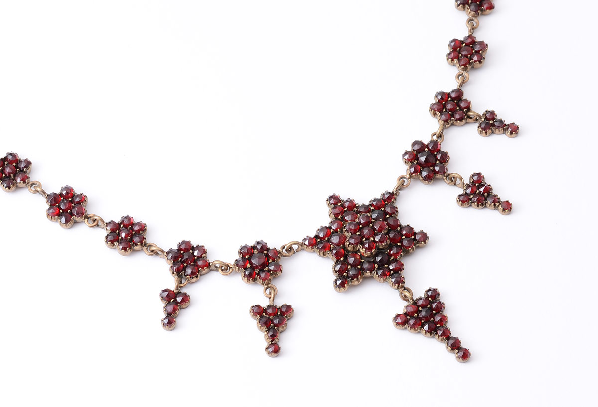 Appraisal: VICTORIAN ERA GARNET NECKLACE Garnet covered star center with drop