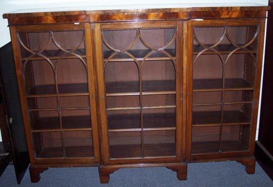 Appraisal: A late th Century mahogany breakfront bookcase fitted glazed panel